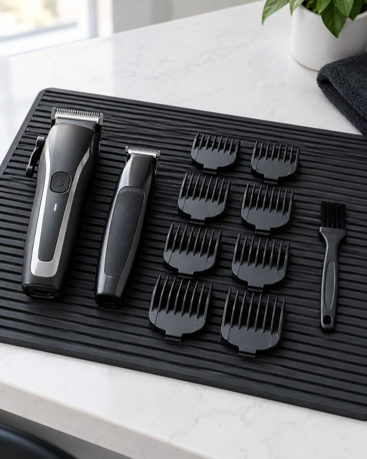 Illustrative beginner barber setup with clippers, a trimmer and attachment guards arranged on a black tool mat